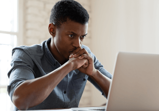 Safety and Security man looking at his laptop